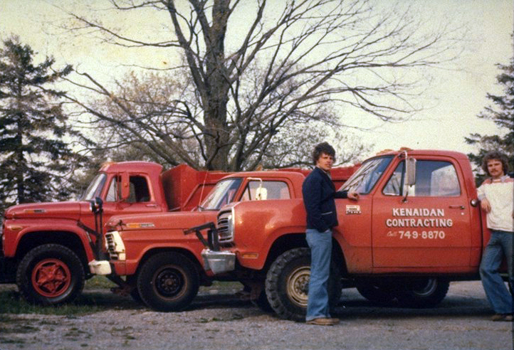 Company founders Ken and Aidan standing next to company trucks