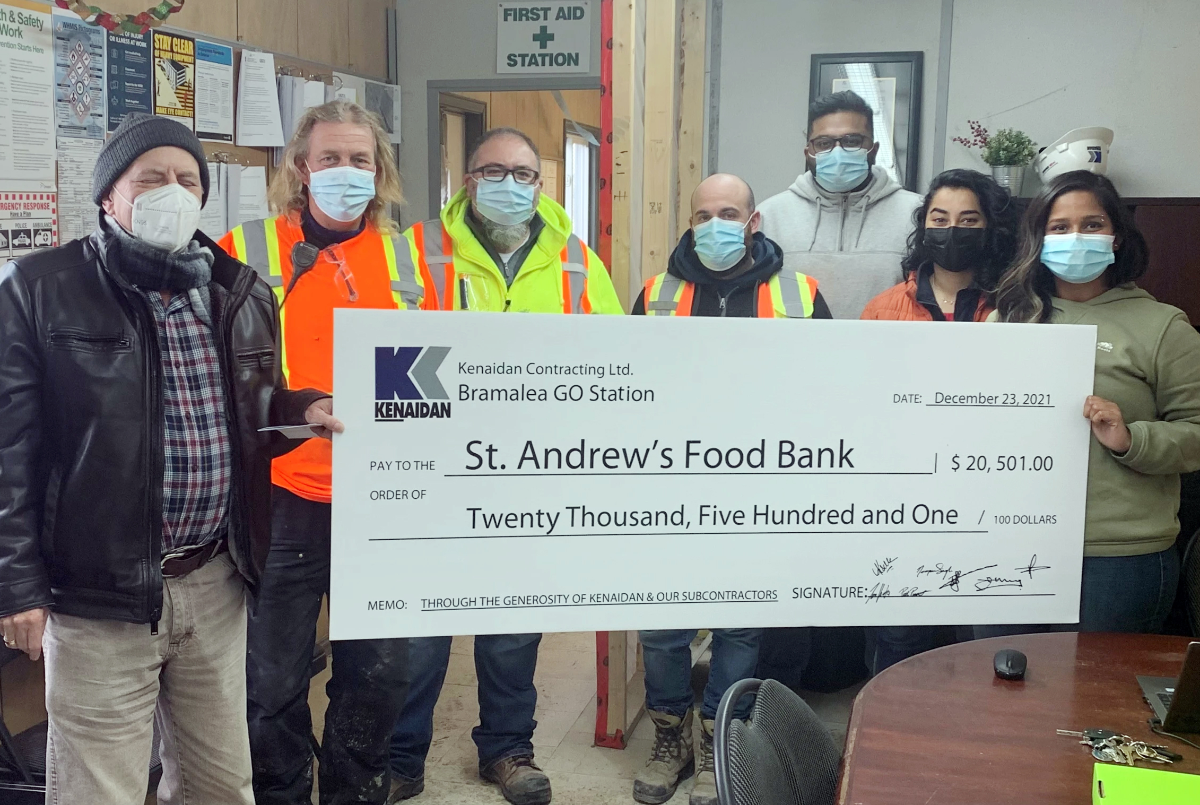 group photo of Kenaidan employees handing over a cheque for charity
