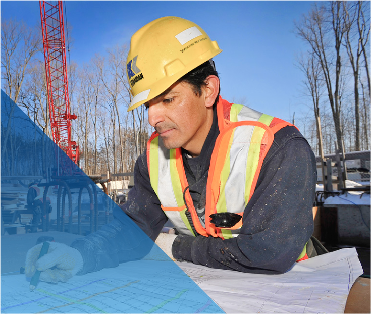 construction worker looking at blueprints