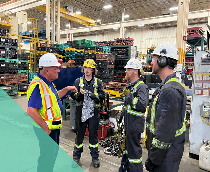 four warehouse workers having a discussion