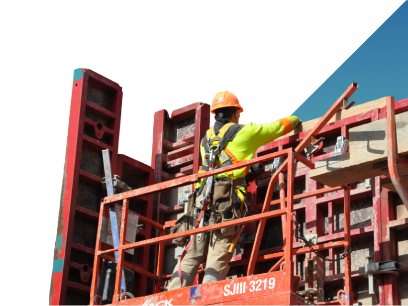 construction worker on a lift building a support wall