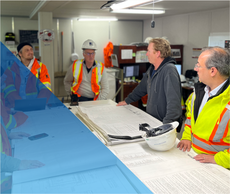 a group of construction workers having a discussion at an office table