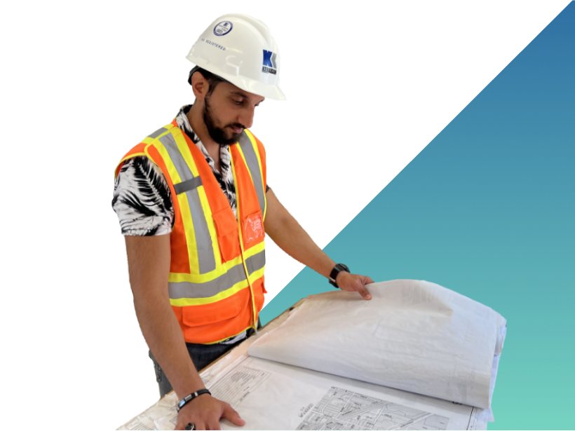 construction worker looking at blueprints