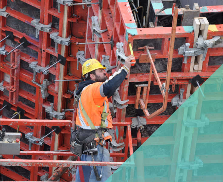 construction worker on a lift taking measurements