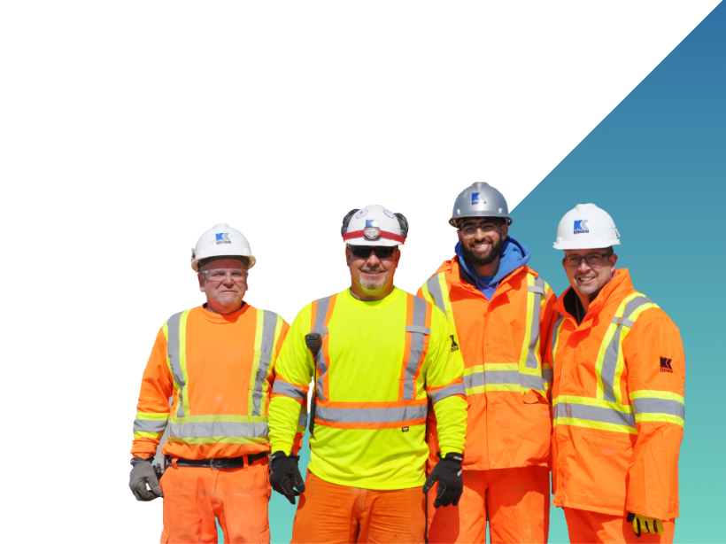group photo of construction workers wearing orange PPE