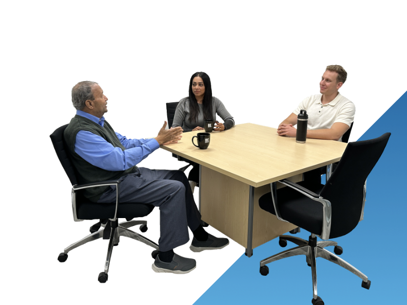 Three Kenaidan employees sitting at an office table
