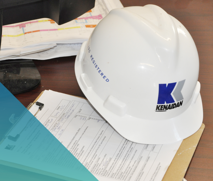 Image of a Kenaidan hard hat and clipboard on a table